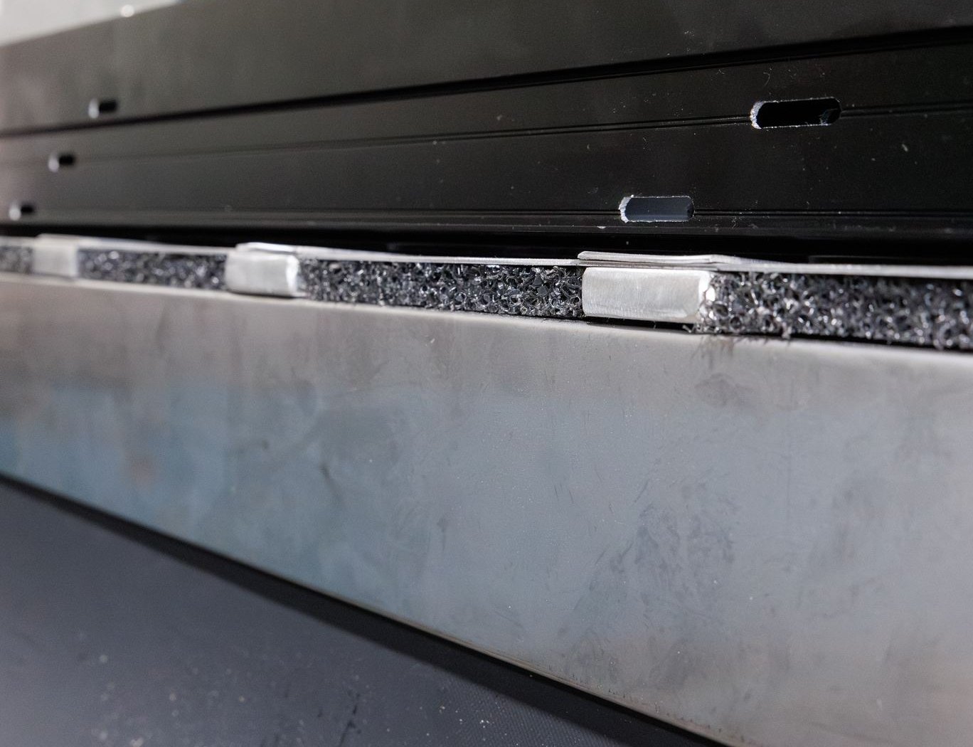 Bottom track resting on J&S shims and gasket above the sub sill